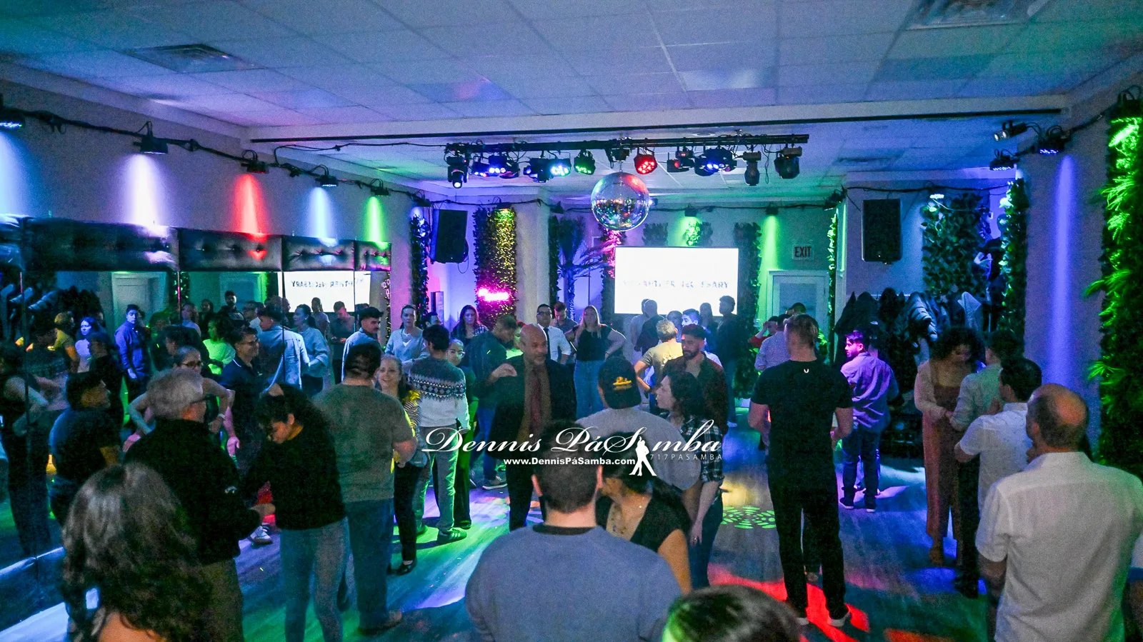 The full studio room filled with dancers during an evening social