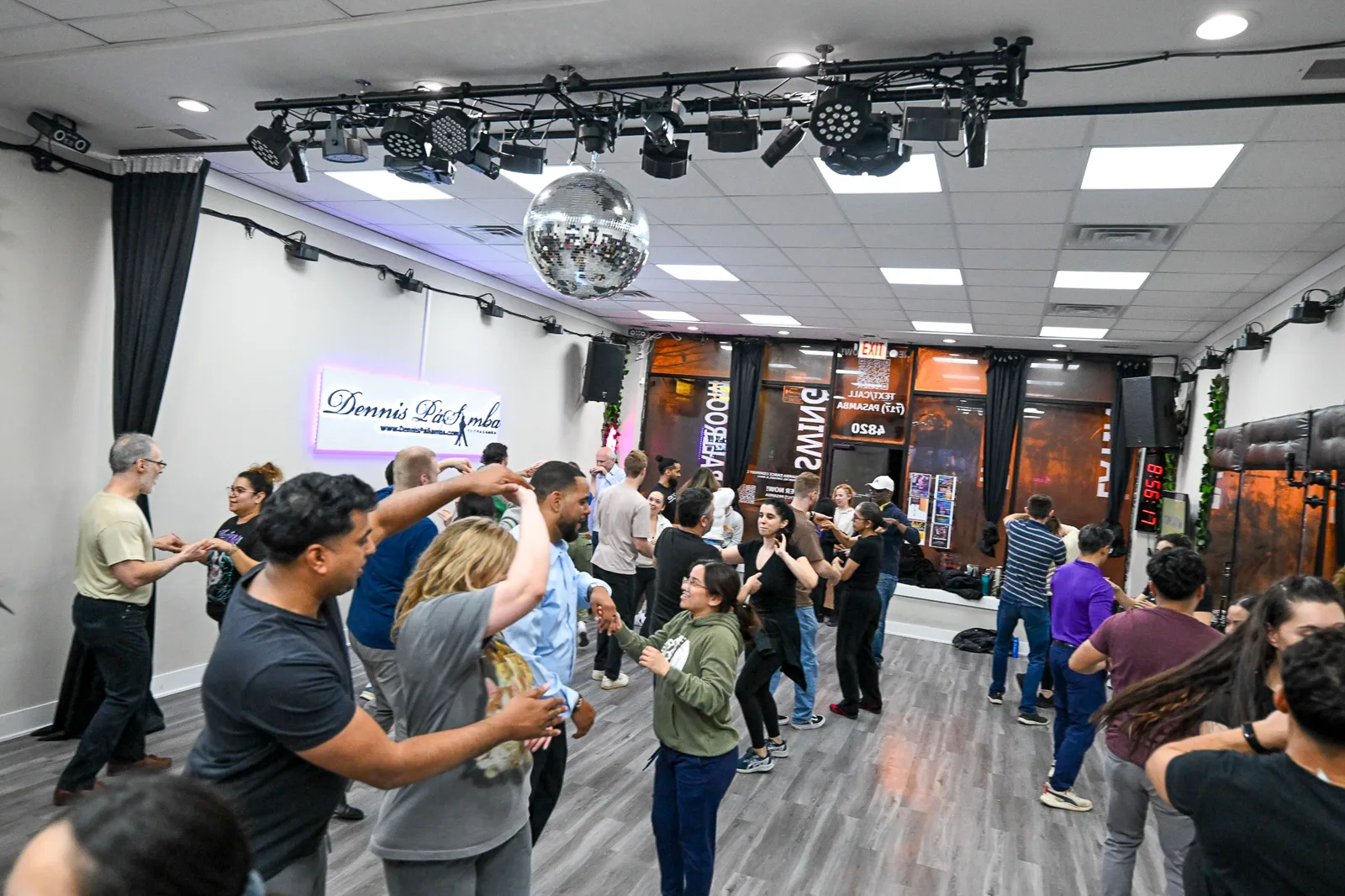 The Dennis PaSamba studio dance floor with disco balls and stage lighting