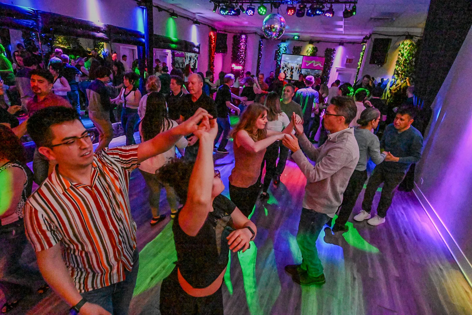 Partners dancing salsa on1 at the Chicago studio