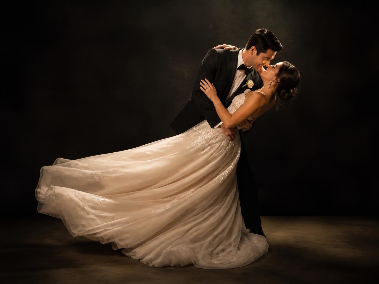 Wedding couple in a graceful dip during their first dance