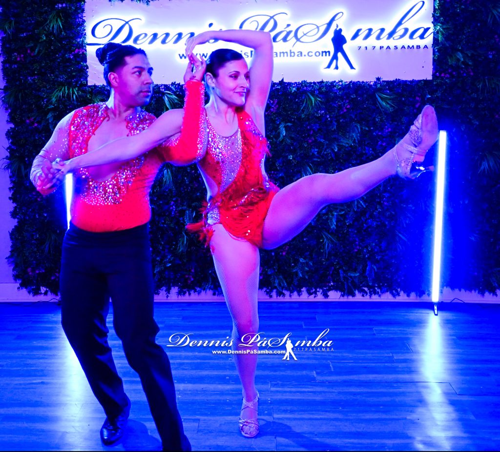 Professional salsa dancers performing surprise flash mob entrance at Chicago wedding or party venue, guests reacting with delight, high-energy Latin entertainment by Dennis PaSamba Dance Company