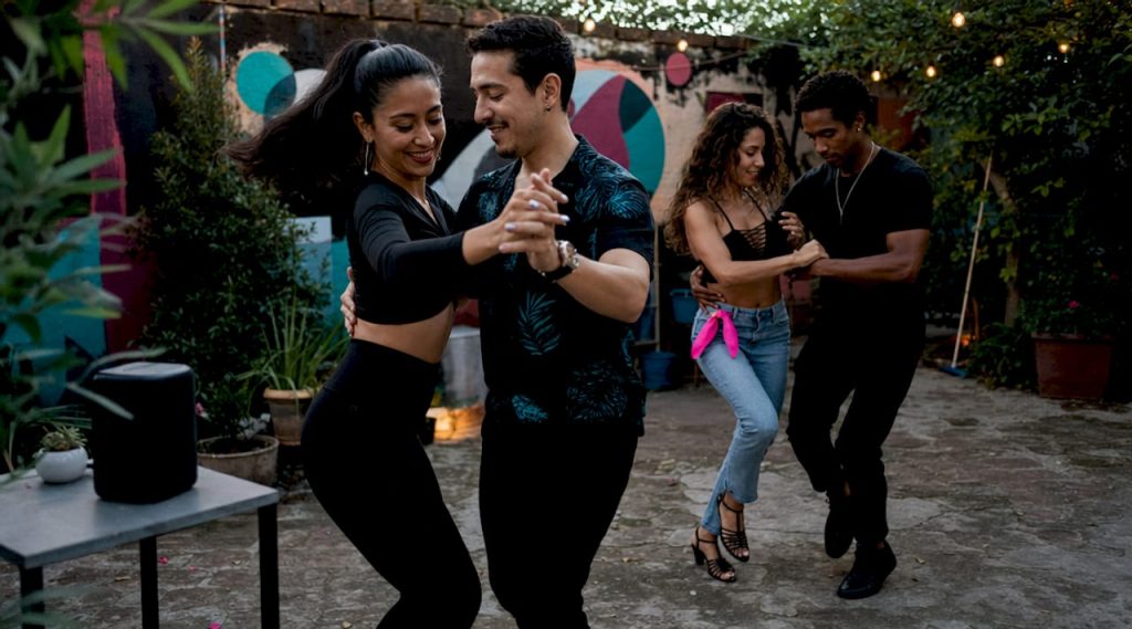Couples dancing salsa and bachata in studio