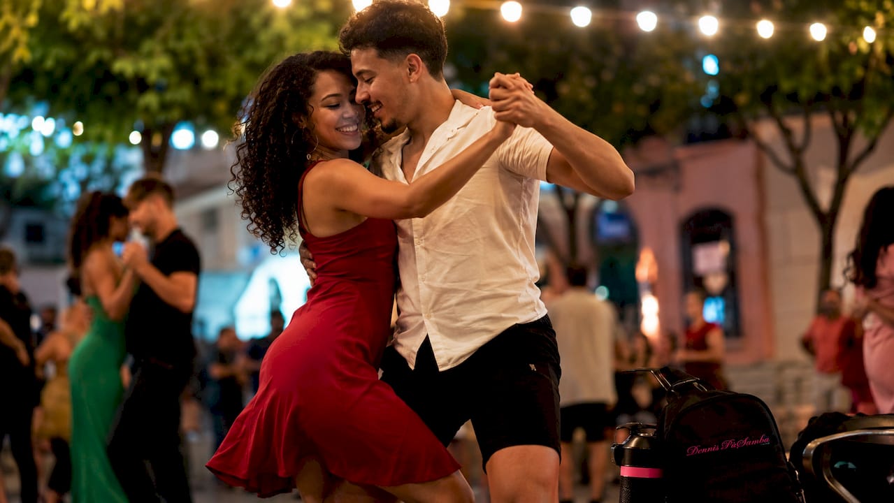 Couple dancing romantically in Latin dance studio